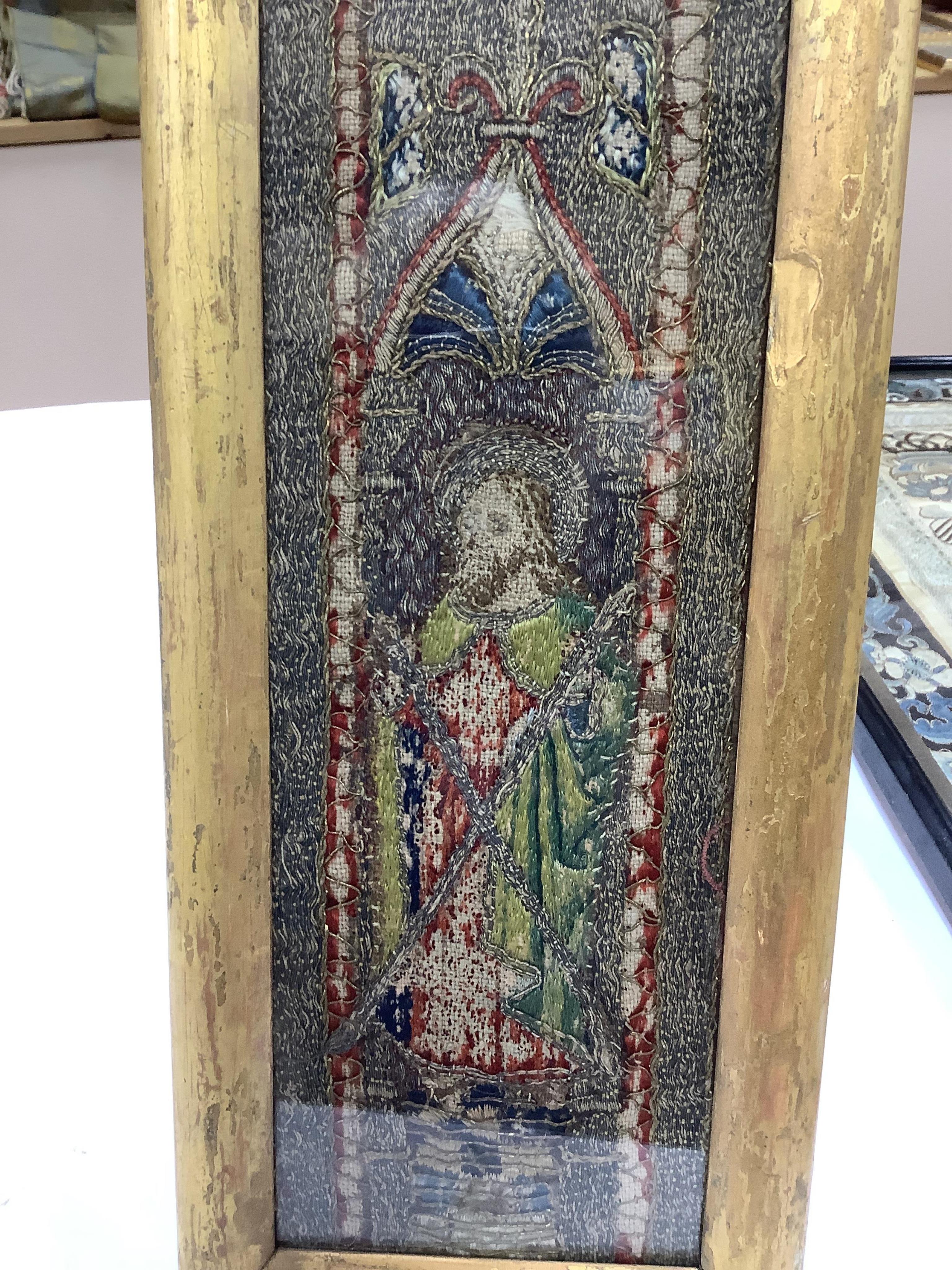 An early 16th century ‘Opus Anglicanum’ (English work), silk and metal thread embroidered fragment, of Saint Andrew, possibly cut from an orphrey, later framed and glazed, 28.5cm high x 9.5cm wide. Condition - the silk t